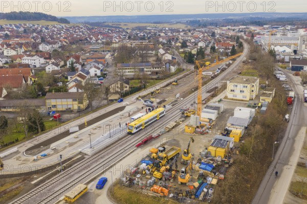 Aerial view of a railway station under construction with cranes and a yellow train, urban environment, Hermann Hesse Railway acceptance, Althengstett, Black Forest, Germany