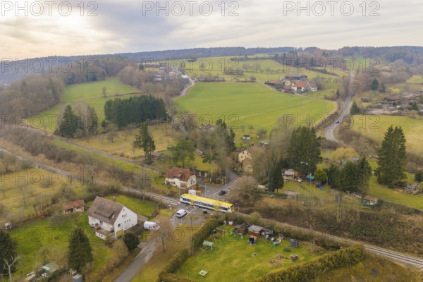 Aerial view of a rural area with trains, fields and small villages in the background, departure of the Hermann Hesse Railway, Calw, Black Forest, Germany