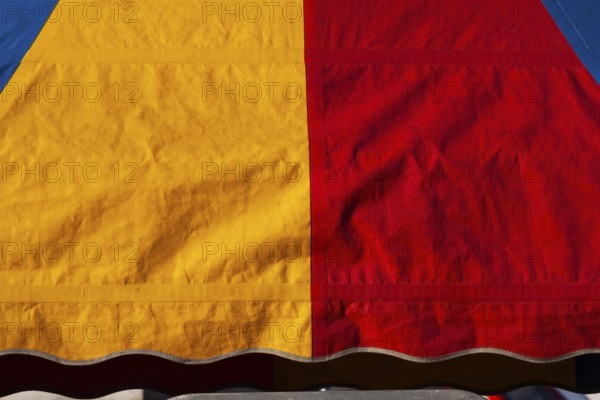 Close-up of yellow, red and blue dyed canvas cloth material, Quebec, Canada