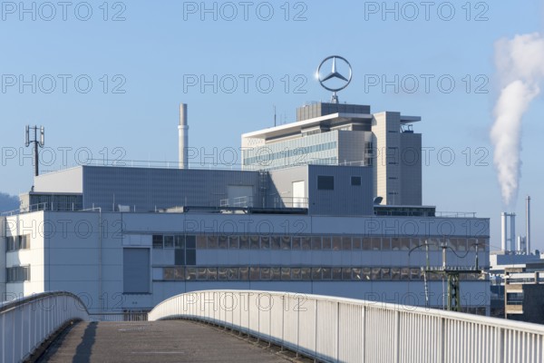 Industrial plant with Mercedes logo on the roof and smoking chimney, crossed by a bridge, Mercedesstern, Stuttgart-Untertürkheim, Baden-Württemberg, Germany
