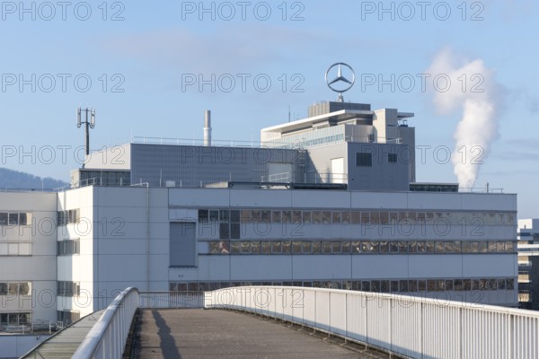 Modern industrial building with Mercedes logo and smoking chimney in the background, blue sky, Mercedes star, Stuttgart-Untertürkheim, Baden-Württemberg, Germany