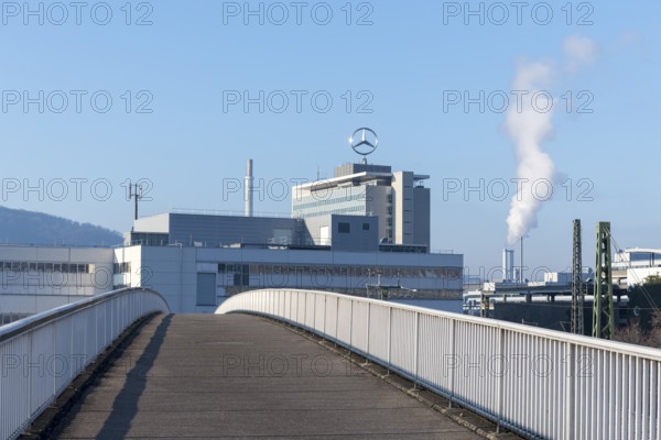 Industrial complex with Mercedes logo and smoking chimney, crossed by bridge, blue sky, Mercedes star, Stuttgart-Untertürkheim, Baden-Württemberg, Germany