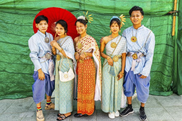 A group of young people wearing traditional clothing presents themselves for the photographers, Wat Arun Buddhist temple, Bangkok, Thailand's metropolis, Thailand