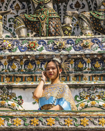 Young woman in traditional clothing presents herself to photographers, Wat Arun Buddhist temple, Bangkok, Thailand's metropolis, Thailand