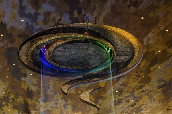 Artificial, brightly lit waterfall, Magic Waterfall, falls from the ceiling of the Iconsiam shopping center, Bangkok, Thailand's metropolis