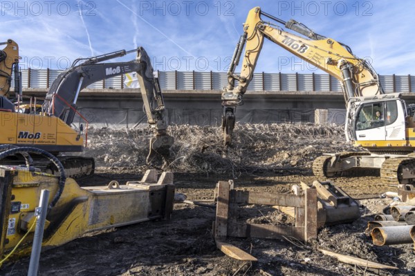Demolition of the 120 meter long motorway bridge of the A516, across Teutoburger Straße in Oberhausen-Sterkrade, the bridge, built in 1970 was severely damaged, traffic continues to roll on the still existing West Bridge, after the demolition, the eastern part is rebuilt using a process unique in the world, 40 meter long precast concrete beams are assembled one after the other, reducing the construction period from 24 to 7 months after the completion of this bridge Will the western part also be rebuilt, North Rhine-Westphalia, Germany