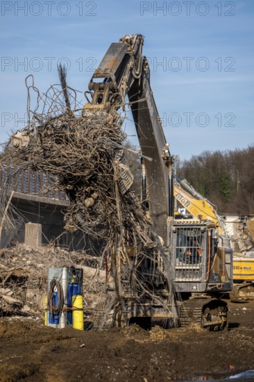 Demolition of the 120 meter long motorway bridge of the A516, across Teutoburger Straße in Oberhausen-Sterkrade, the bridge, built in 1970 was severely damaged, traffic continues to roll on the still existing West Bridge, after the demolition, the eastern part is rebuilt using a process unique in the world, 40 meter long precast concrete beams are assembled one after the other, reducing the construction period from 24 to 7 months after the completion of this bridge Will the western part also be rebuilt, North Rhine-Westphalia, Germany