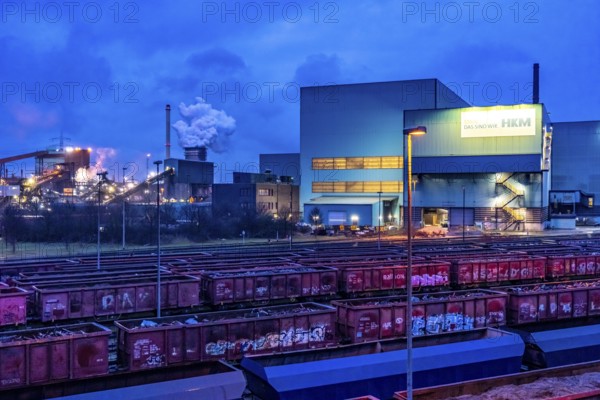 Hüttenwerke Krupp-Mannesmann, HKM in Duisburg, houses of the blast steel plant, coking plant, extinguishing tower with fire cloud, marshalling yard tracks, freight wagon with scrap metal, for melting down, North Rhine-Westphalia, Germany