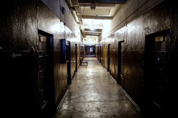 Dark corridor of the Karosta prison in Liepaja with visible cell doors, Liepaja, Courland, Latvia
