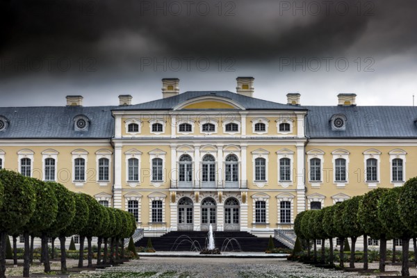 Magnificent baroque castle with imposing façade under dramatic clouds, Rundale, Latvia