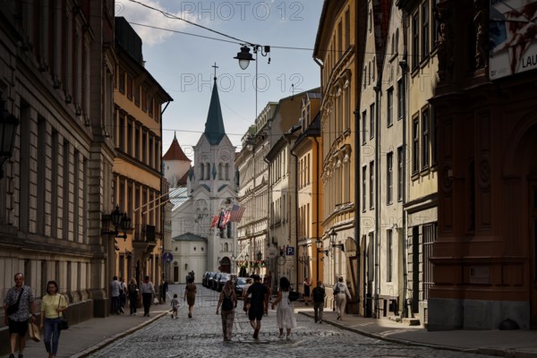 Castle Street with Maria Schmerzen Church and lively street life in Riga, Riga, Latvia
