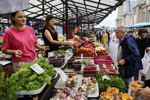 Saleswomen present fresh products at the Central Market in Riga, Riga, Central Market, Latvia