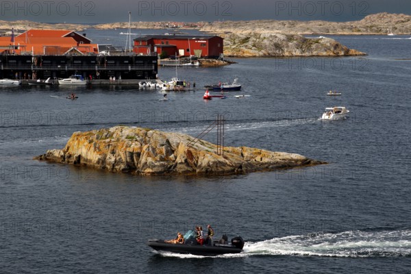 Busy water near Klädesholmen with boats and distinctive coastal cliffs, Klädesholmen, Sweden