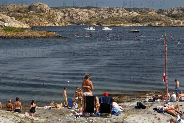Summer beach on Klädesholmen with relaxed atmosphere and people bathing, Klädesholmen, Sweden