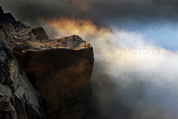 Prekestolen ledge in fog at sunrise, dramatic atmosphere