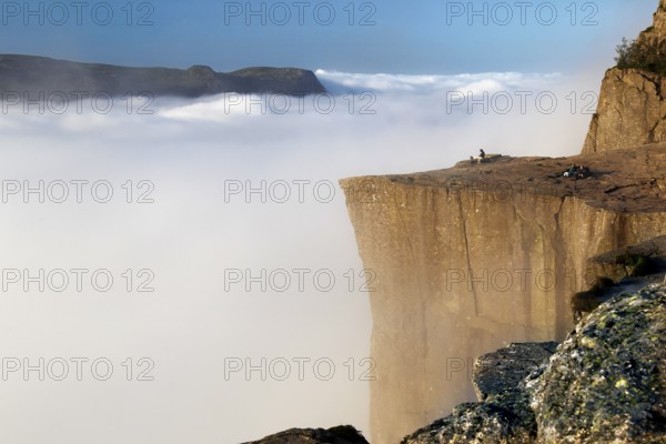 Breathtaking view from Prekestolen over a sea of clouds in a peaceful atmosphere