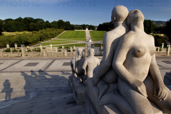Group of granite figures in sunlight with view of parkland, Oslo, Norway