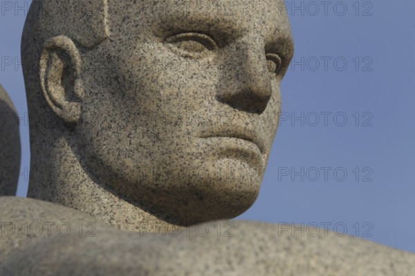 Detail of a granite sculpture in Vigelandsparken shows concentrated face, Oslo, Norway