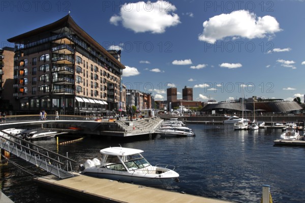Harbour view of Tingvallakaja with modern buildings and boats under blue sky, Oslo, Norway