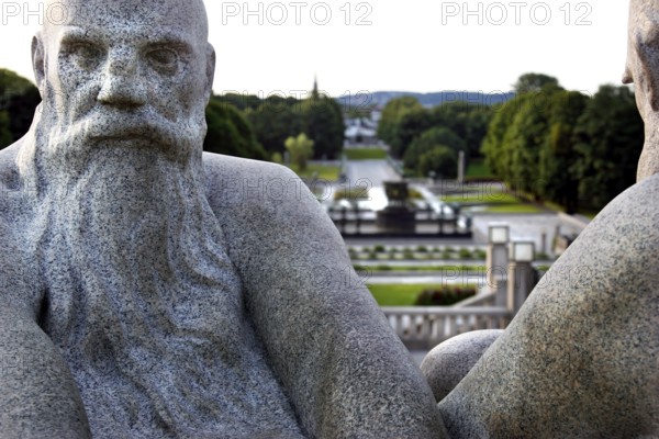 Granite figures in Vigeland sculpture park with green parkland in the background, Oslo, Norway