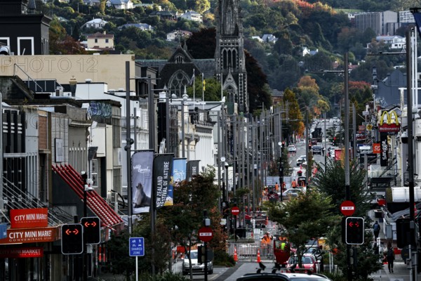 Lively shopping street with historic buildings and hills in the background in Dunedin, Dunedin, Otago, New Zealand