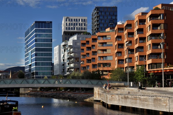 Colourful modern facades along the water in bright blue sky, Oslo, Norway