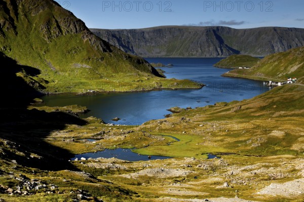 Landscape with fjord-like water and green slopes on Magerøya, Magerøya, Norway