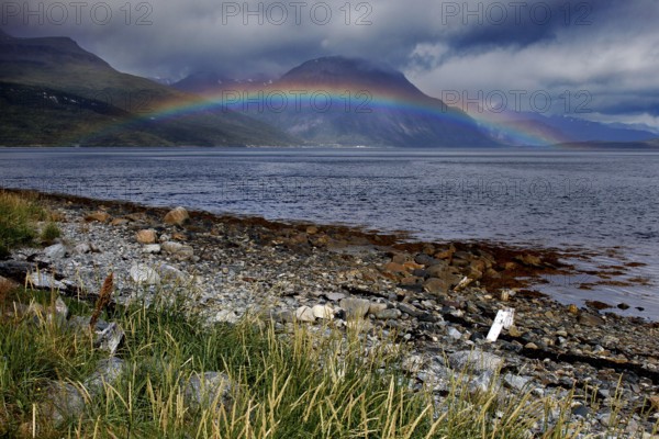 Rainbow over Lyngen Fjord with dramatic coastal landscape, Lyngen Fjord, Troms, Norway