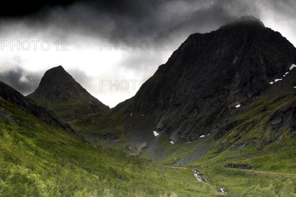 Dramatic mountain scenery under gloomy sky in Bergsbotn, Senja, Norway