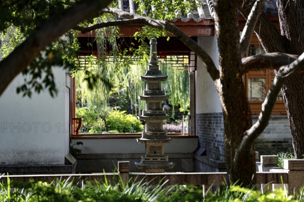 Pagoda and garden view through a window in the Chinese Garden of Friendship, Sydney, New South Wales, Australia
