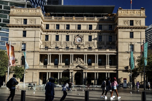 Historic view of Customs House with passers-by and colorful flags, Sydney, New South Wales, Australia