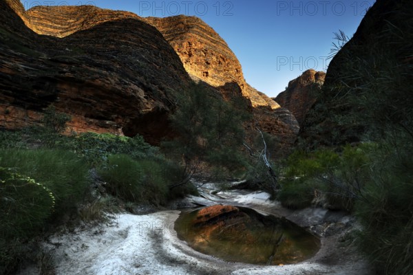 Circularly shaped rock formations and a small stretch of water in Cathedral Cove, Purnululu National Park, Western Australia, Australia