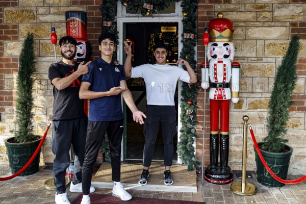 Three people standing smiling in front of a gift shop in Hahndorf, Hahndorf, South Australia, Australia