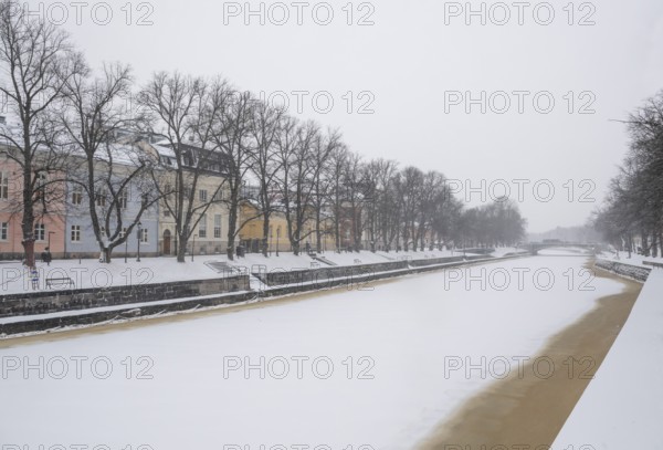 Historic buildings on the frozen Aurajoki river, wintery Turku or Swedish Åbo, Varsinais-Suomi, Finland
