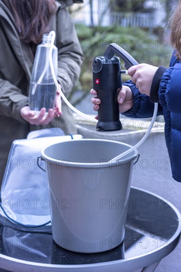 Symbolic picture blackout, extensive, prolonged power failure, in the private environment, without electricity, the water supply also fails, rainwater is made drinkable with the help of a water filter