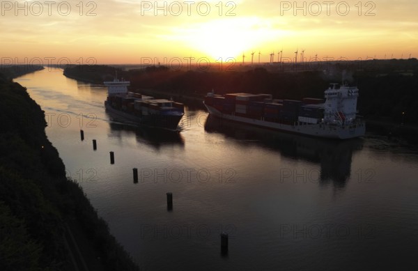 Drone shot, container ship at sunrise in the Kiel Canal, NOK, Kiel Canal, Kiel Canal, Schleswig-Holstein, Germany