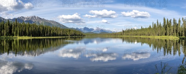 Mountains are reflected in idyllic Crystal Lake, McCarthy Highway, Wrangell St. Elias National Park, Alaska, USA