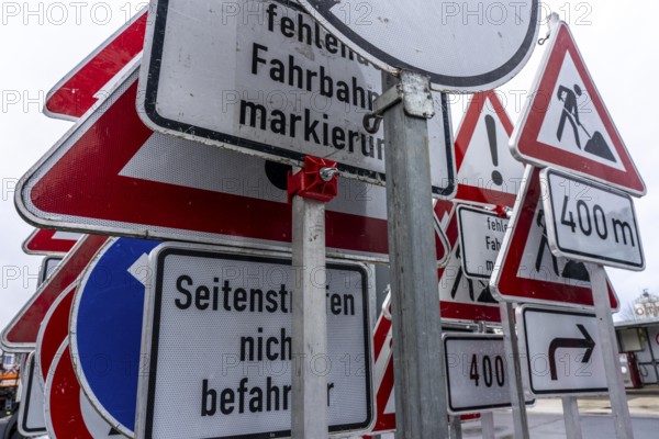 Storage for traffic signs in the yard of a road maintenance department, various signs with commandments and prohibitions, information about dangers, road traffic