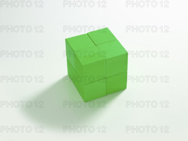 8 green wooden cubes against a white background