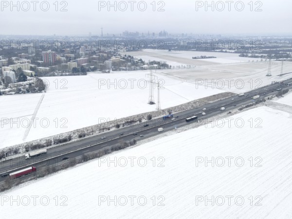 The fields in the north-west of Frankfurt am Main covered in snow. (Aerial view with a drone) On this area of around 550 hectares, between Praunheim, Nordweststadt, Niederursel and the neighbouring communities of Steinbach and Weißkirchen, the new Quartiere district with 6, 800 flats for 17, 000 people and 5, 000 new jobs is to be built along the A5 federal motorway. The project is expected to cost around 1 billion euros, Northwest, Frankfurt am Main, Hesse, Germany