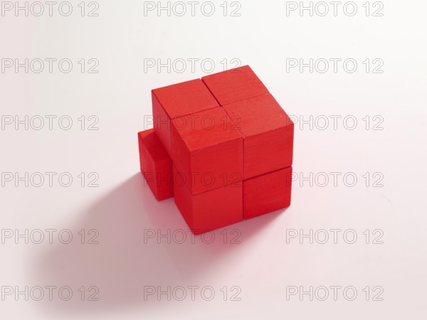8 red wooden cubes against a white background