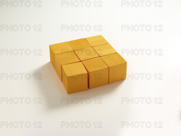 9 yellow wooden cubes against a white background