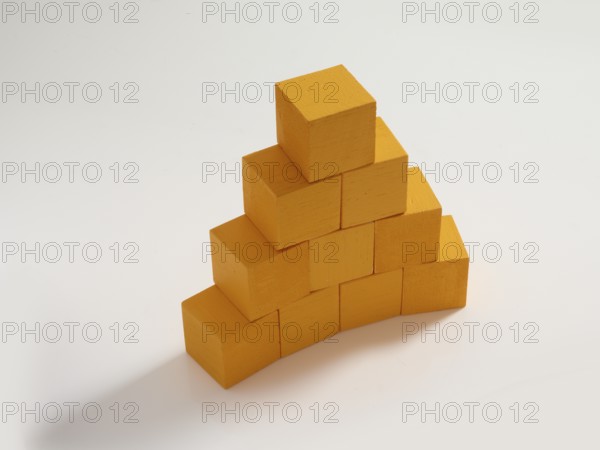 10 yellow wooden cubes against a white background