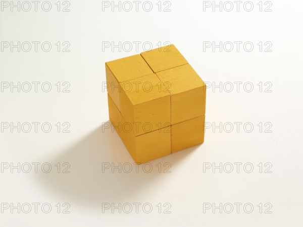 8 yellow wooden cubes against a white background