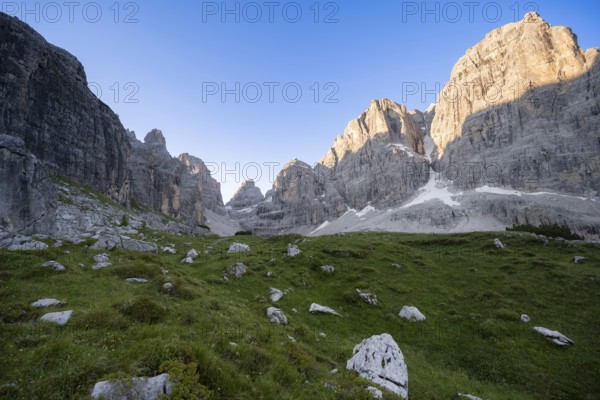 Picturesque mountain landscape in Val Brenta Alta at sunrise, rocky peaks of Cima Tosa, Alpenglühen, Brenta, Trentino, Italy
