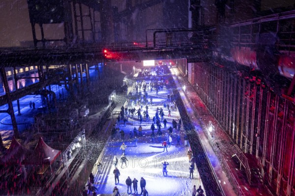 Ice rink at the Zollverein coking plant, ice skating with music and many lighting effects, Essen, North Rhine-Westphalia, Germany