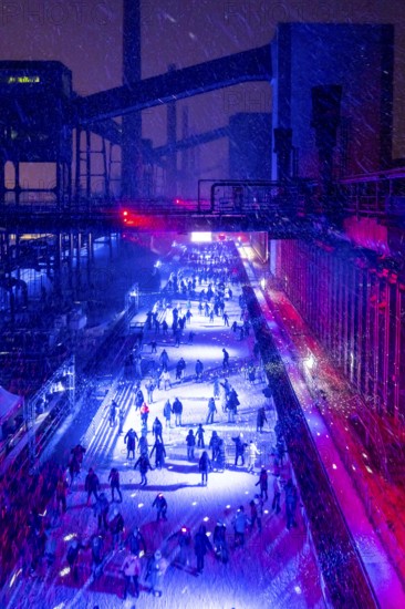 Ice rink at the Zollverein coking plant, ice skating with music and many lighting effects, Essen, North Rhine-Westphalia, Germany