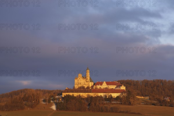 Benedictine monastery with late baroque monastery church, lighting atmosphere, winter, Neresheim, Härtsfeld, Swabian Jura, Baden-Württemberg, Germany