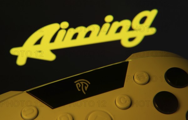 Dhaka, Bangladesh- 24 Mar 2025: A close-up of a gamepad with the Aiming Inc seen on screen in the background