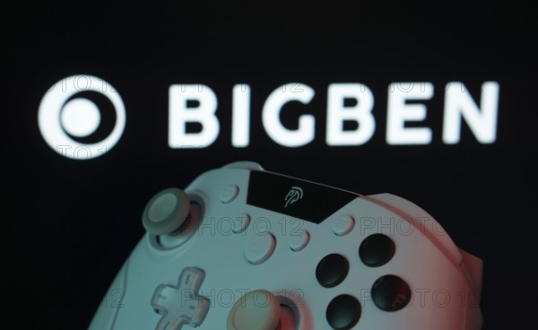 Dhaka, Bangladesh- 20 Mar 2025: A close-up of a white gamepad with the Bigben Interactive seen on screen in the background